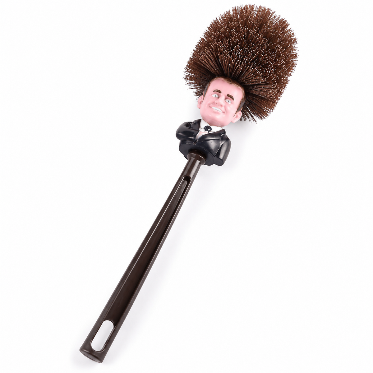 Brosse WC Macron entière sur fond blanc, avec visage caricatural, poils bruns et long manche foncé.